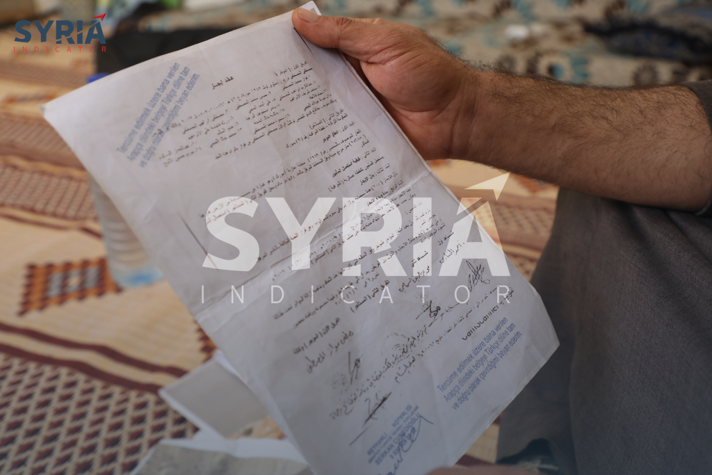 The proprietor of the agricultural estate, Mustafa Fawaz Al-Mustafa, within his residence at the "Morek" camp, situated in Eastern Kalli, holds in his possession the Arabic rendition of the contract leasing his land to the Turkish observation post - November 5, 2023, "Syria Indicator."